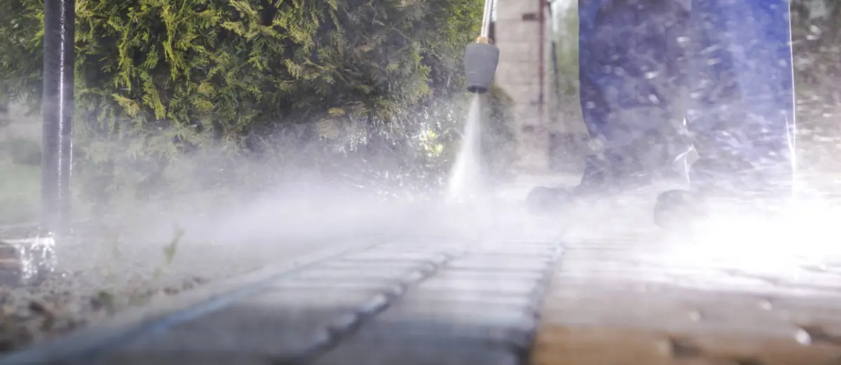 Man power washing a brick walkway in South Jersey