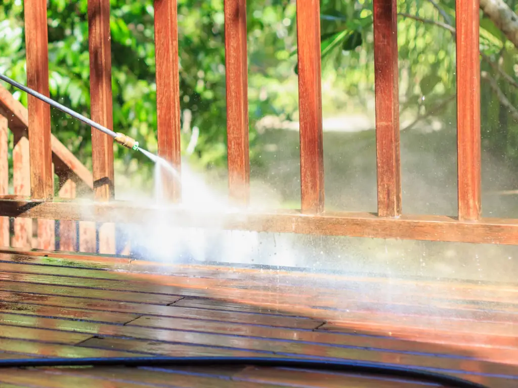 Professional deck pressure washing service restoring weathered wood boards at an Avalon, NJ beach house — removing algae, salt residue, and embedded grime.