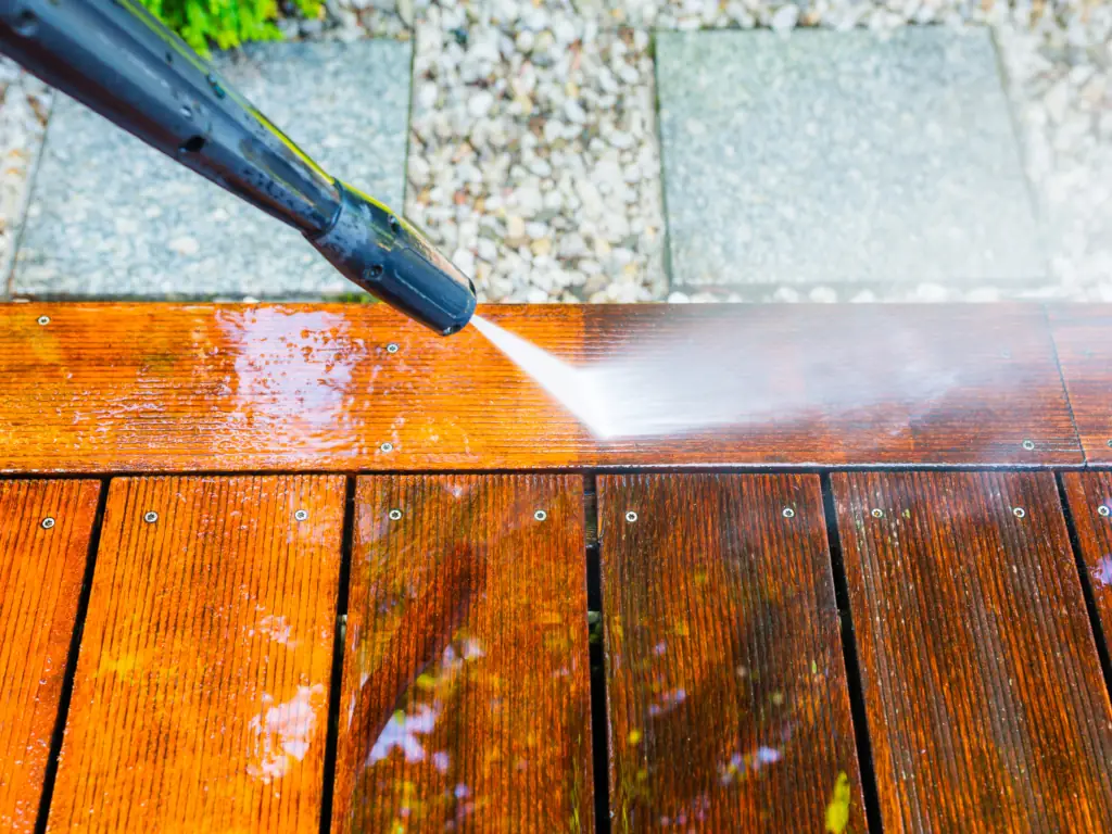 Pressure washing wooden deck planks on an Avalon, NJ beach house — removing salt residue, algae, and weathered grime to restore the deck before summer rental season.
