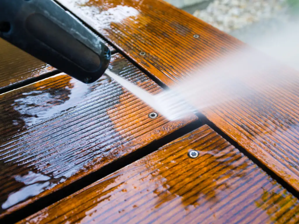 Pressure washing a grooved composite wood deck on a Moorestown, NJ property — removing algae, mildew, and weathered surface buildup from large residential outdoor decking.