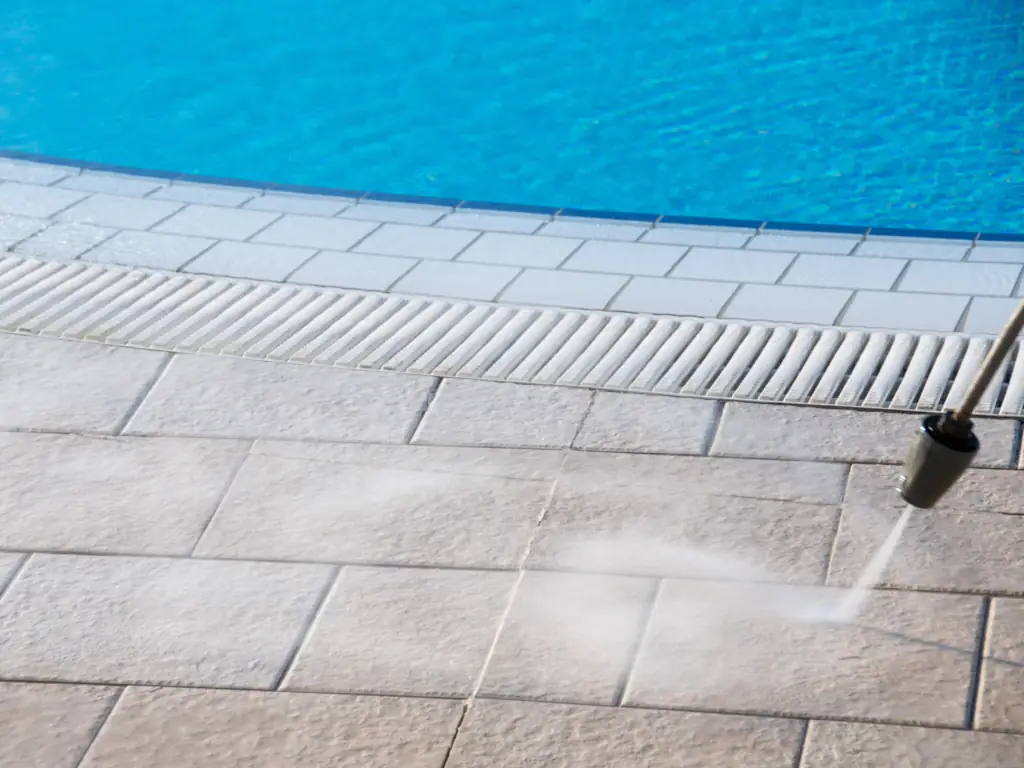 Pool deck and sidewalk pressure washing in Mullica Hill, NJ — removing algae, moss, and embedded grime from concrete and paver surfaces.