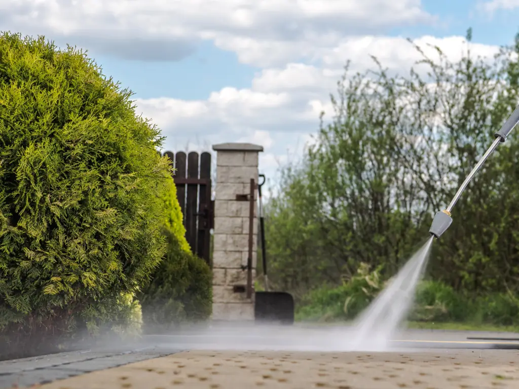 Power washing concrete walkway pavers on a Moorestown, NJ property — removing algae, embedded grime, and weed growth from joints in shaded residential paved surfaces.