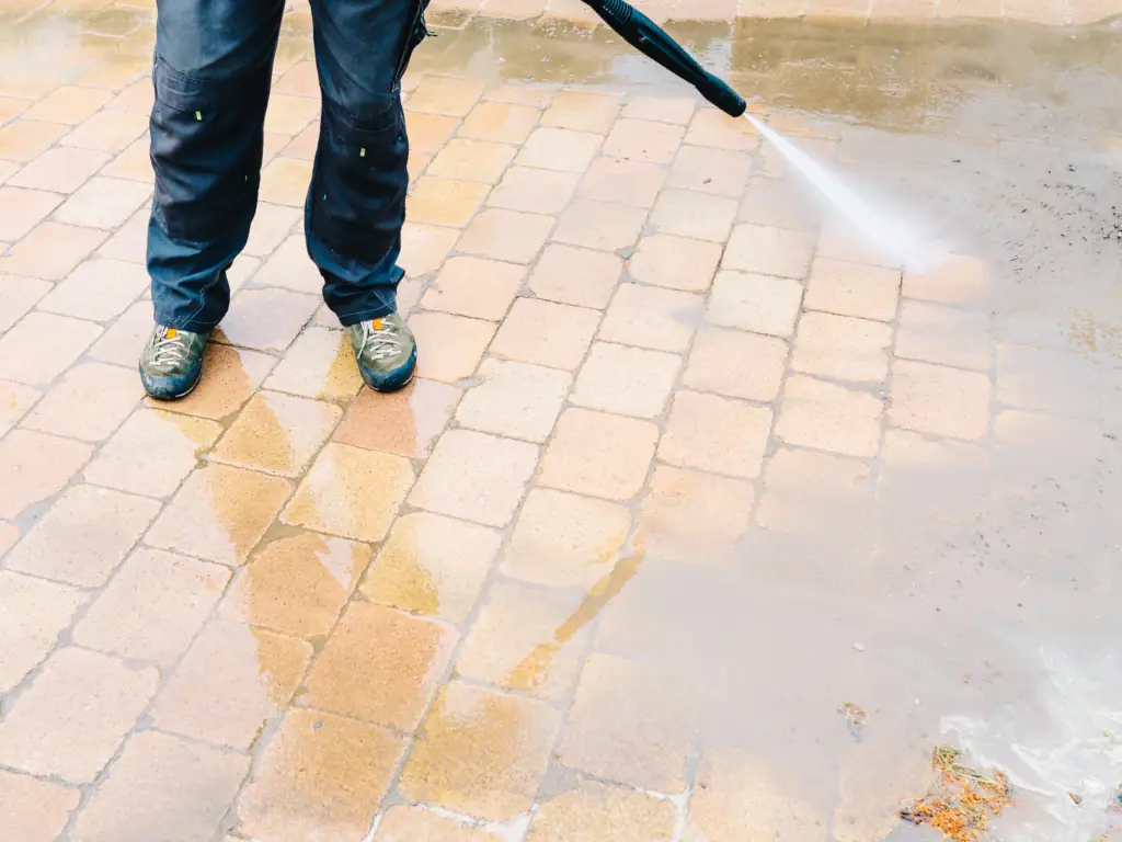 Pressure washing a brick paver driveway on a Stone Harbor, NJ shore property — removing salt residue, algae, and weed growth from coastal hardscape pavers.