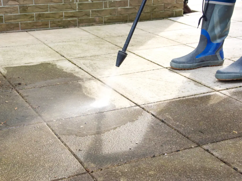 Pressure washing concrete patio pavers on a Mount Laurel, NJ property — removing embedded grime, algae, and surface staining from outdoor hardscape areas.