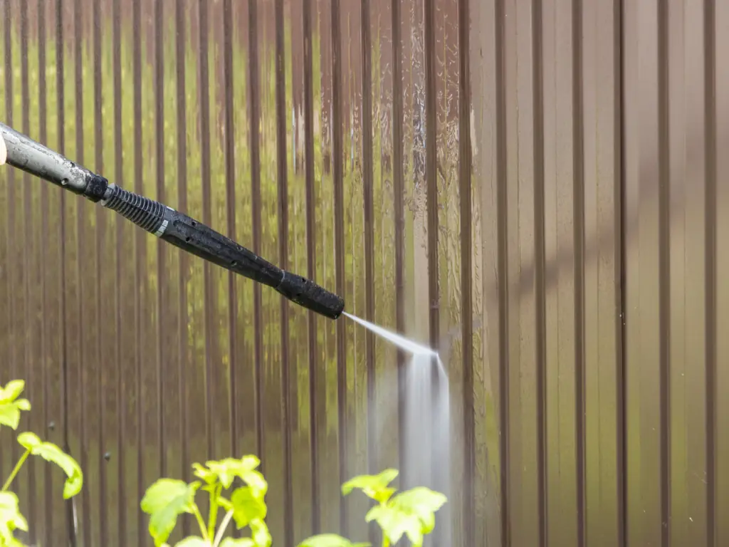 Residential fence pressure washing service on a Mount Laurel, NJ property — removing algae, mold, and weathering from vinyl and wood fence lines across suburban Burlington County yards.