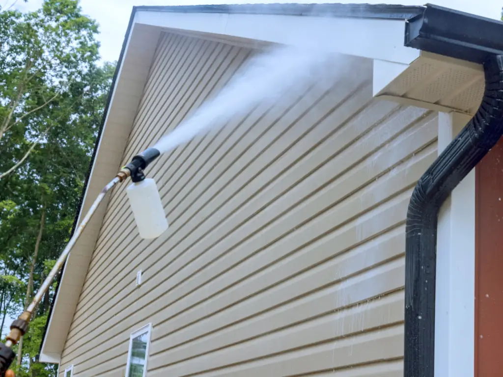 Professional pressure washing of exterior walls and trim on a Stone Harbor, NJ shore home — removing salt deposits, algae, and oxidation from coastal Cape May County properties.