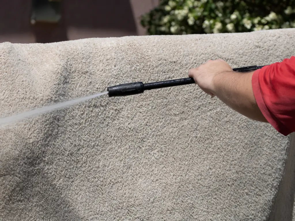 Pressure washing a home cement wall in Swedesboro, NJ — cleaning algae, mold, and staining from exterior masonry and painted surfaces.
